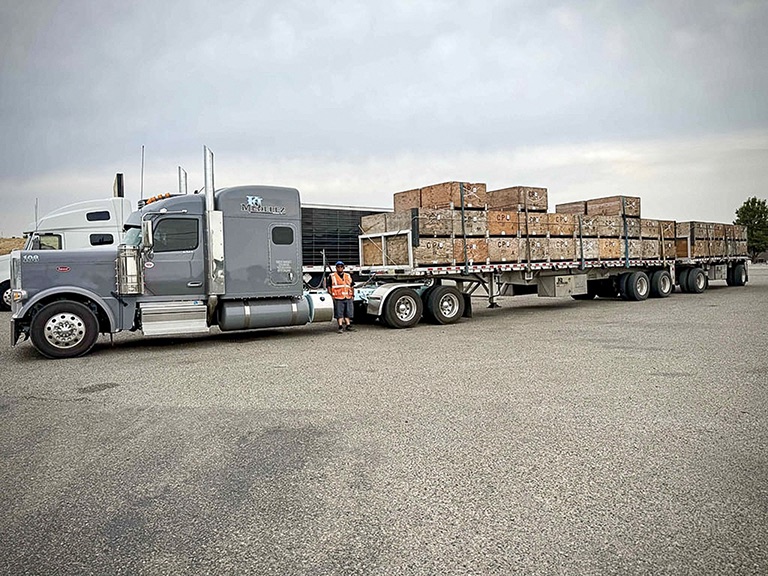 KJ Medelez driver beside a truck and loaded trailers